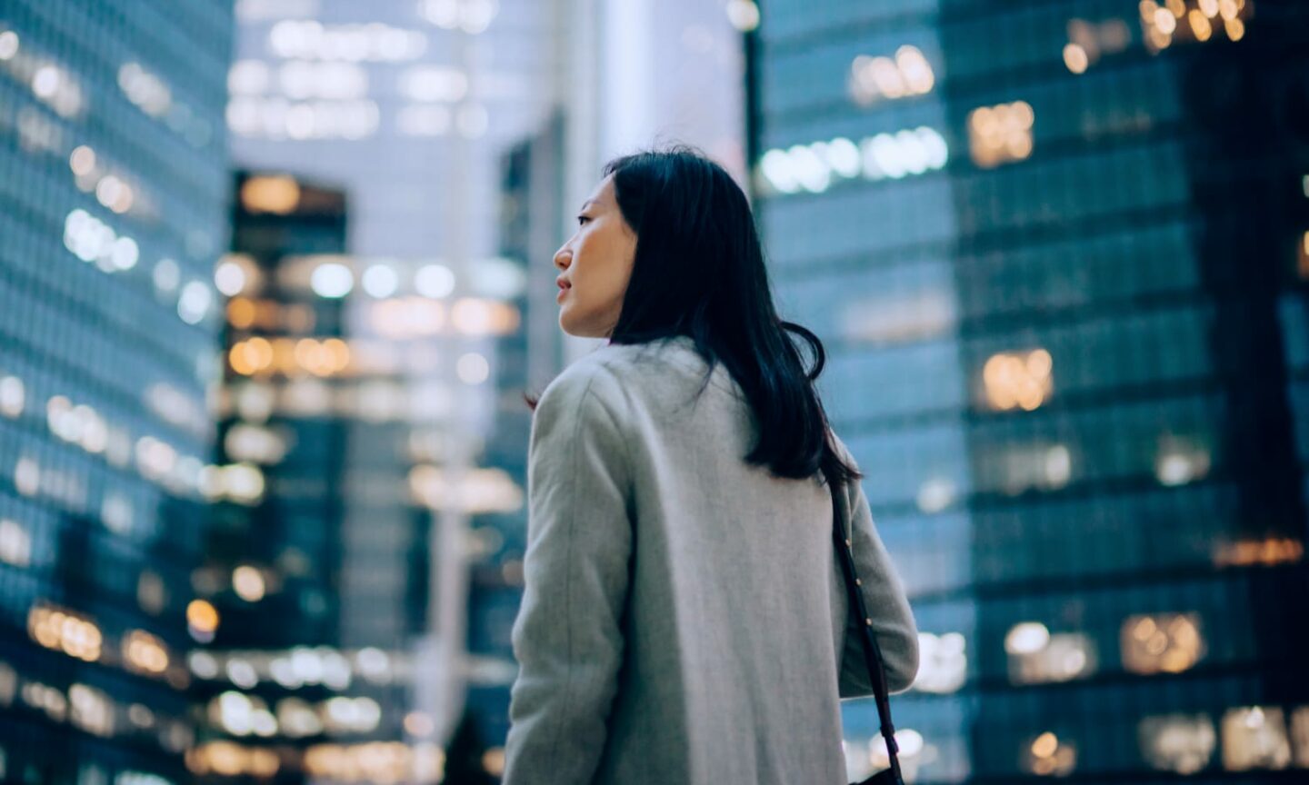 Smart business woman standing outside office buildings