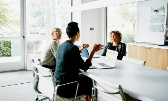 Three people at a business meeting