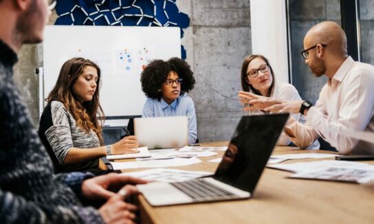 Team meeting of five people in an office