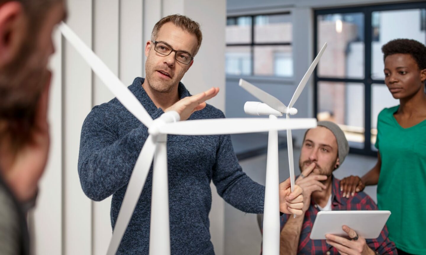 Two men studying wind farm models