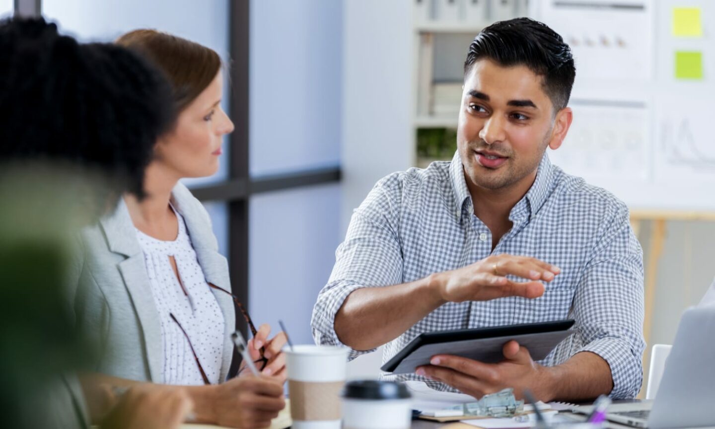 Business meeting with a man using a tablet