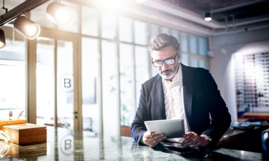 Business man in office looking at a tablet